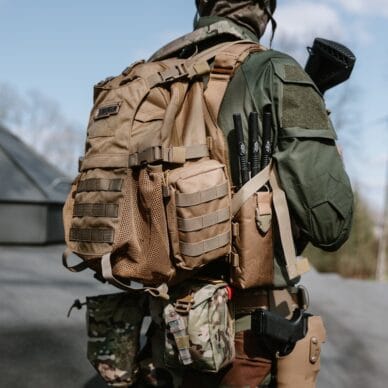 a man in camouflage with a backpack on his back